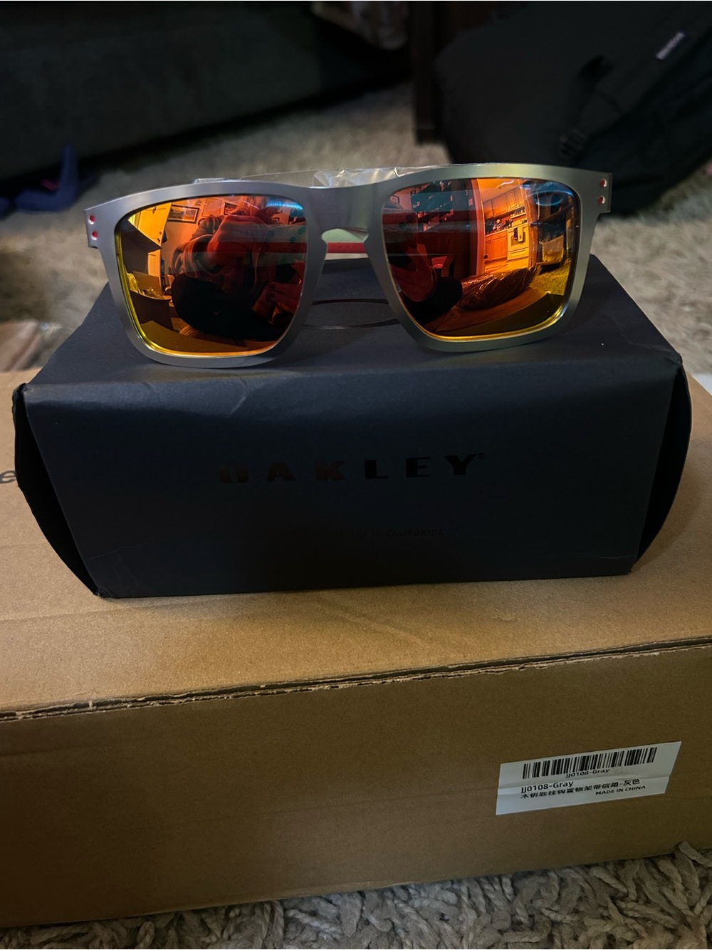 Oakley Silver Frame Sunglasses with Orange-Red Mirror Lenses